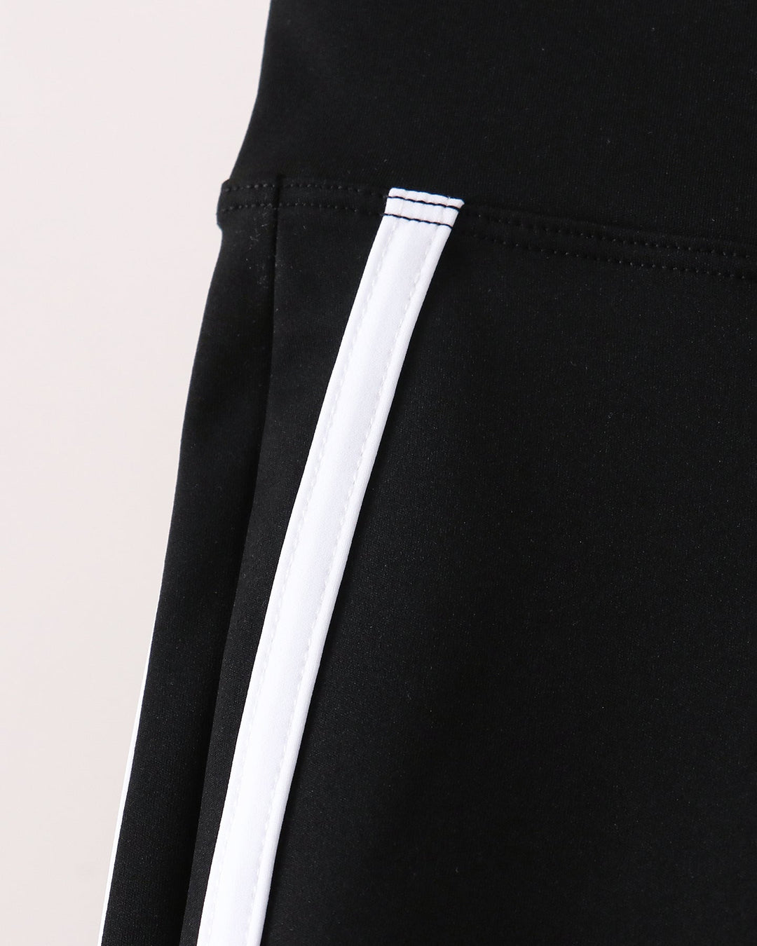 Black pants with vertical white stripe along the outer leg