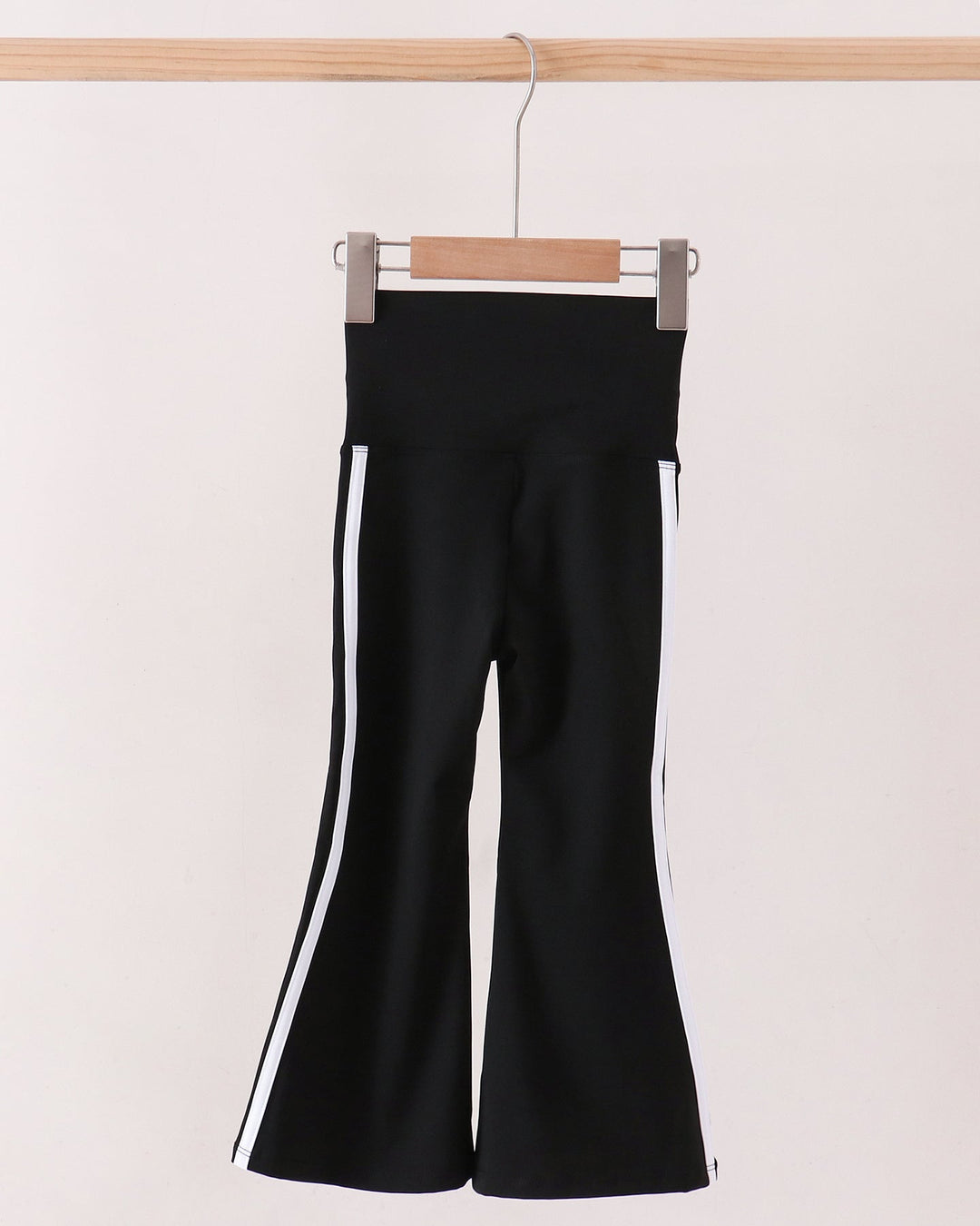 Black flare active pants with double white side stripes and wide bootcut legs