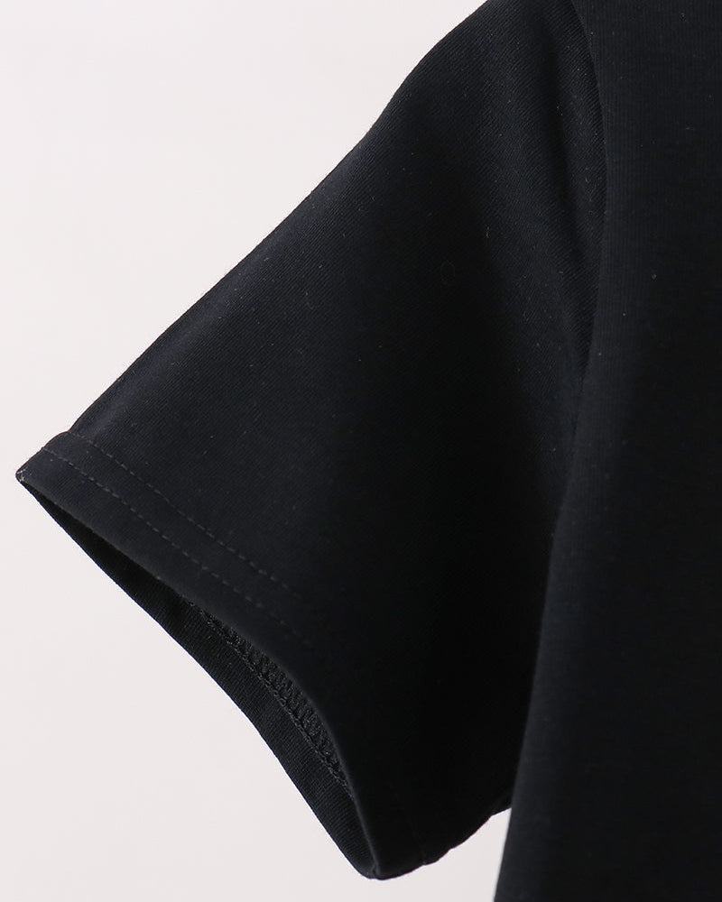 Close-up detail of a black short-sleeve t-shirt showing the clean hemmed edge of the sleeve against a plain light background.