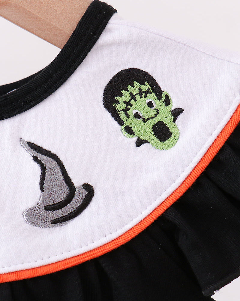 Black romper with white embroidered ruffle panel, green cat face and gray cat silhouette