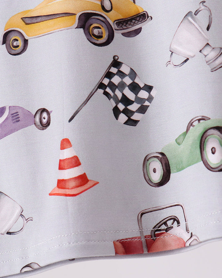 Racing pajama pant cuff with car, flag, and cone print on light fabric