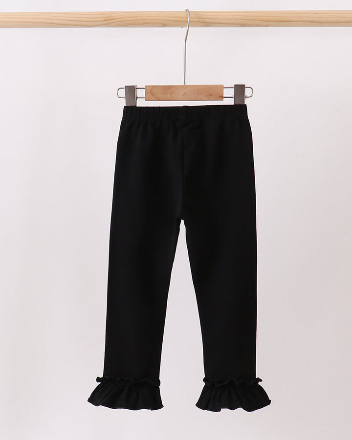 Black ruffle ankle leggings hanging, full-length with elastic waistband