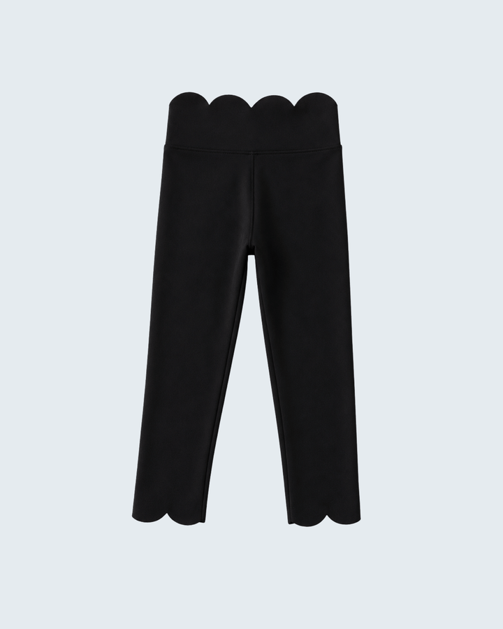 Black pants with scalloped hem on a light gray background