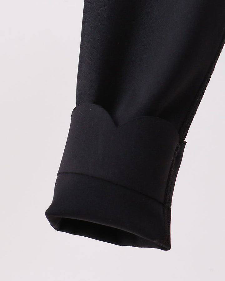 Close-up of a black legging on a white background