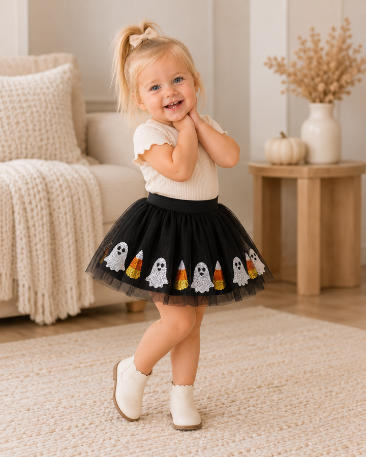 Black tutu skirt worn with white ghost and orange candy corn hem appliques