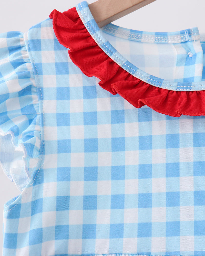 Blue gingham dress with red ruffled collar and flutter sleeves, close-up