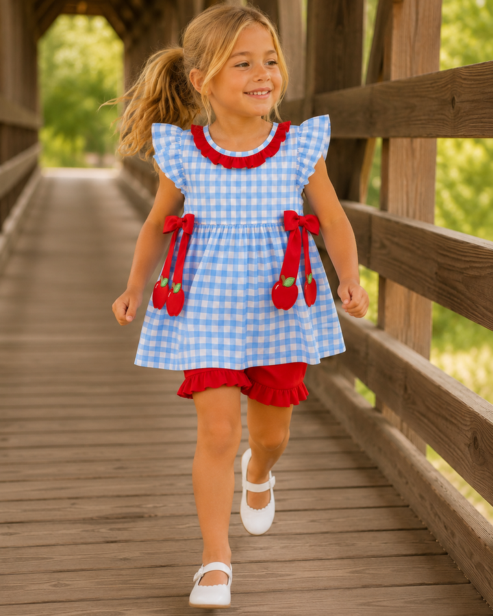 Blue gingham ruffle dress set with red trim, apple appliqués, and red shorts