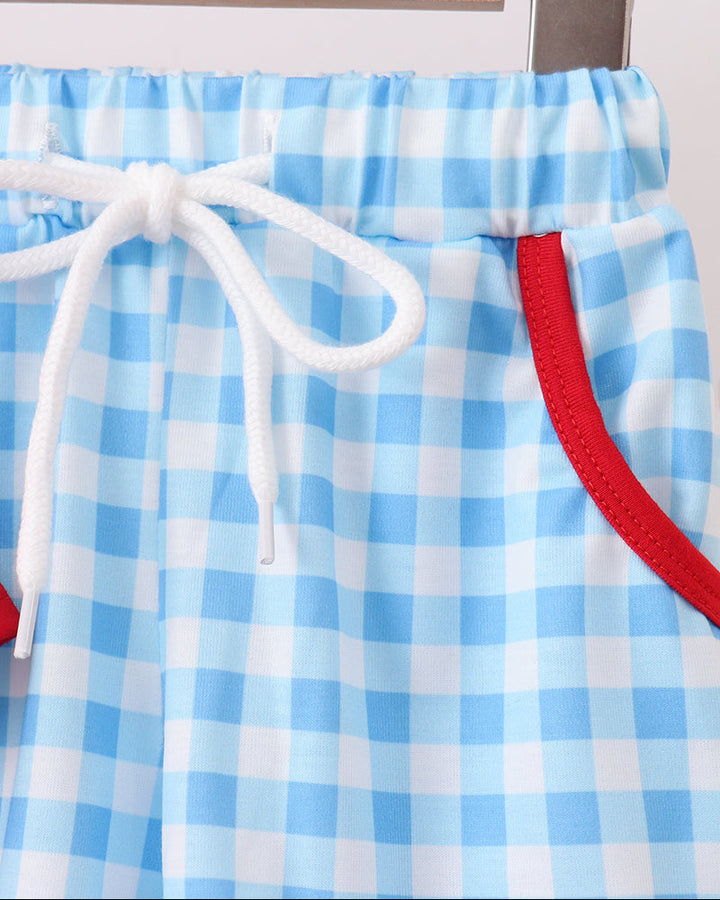 Blue gingham drawstring shorts with red trim and gathered waistband