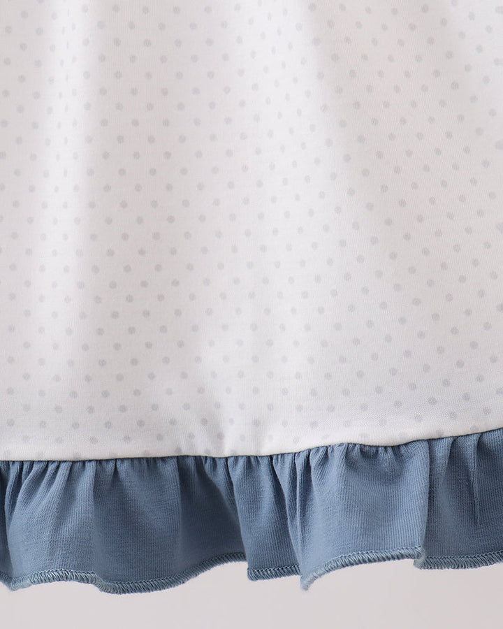 Girls white dotted dress with blue ruffle hem trim and gathered skirt