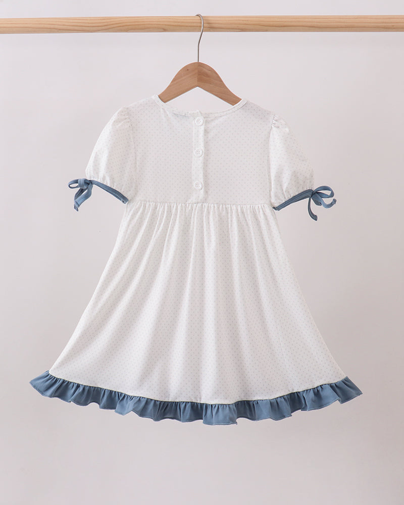 Girls white dotted dress with blue ruffle hem, bow sleeves, and gathered skirt