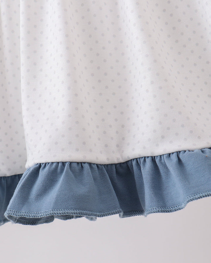 White dotted ruffle top with light blue hem ruffle finish