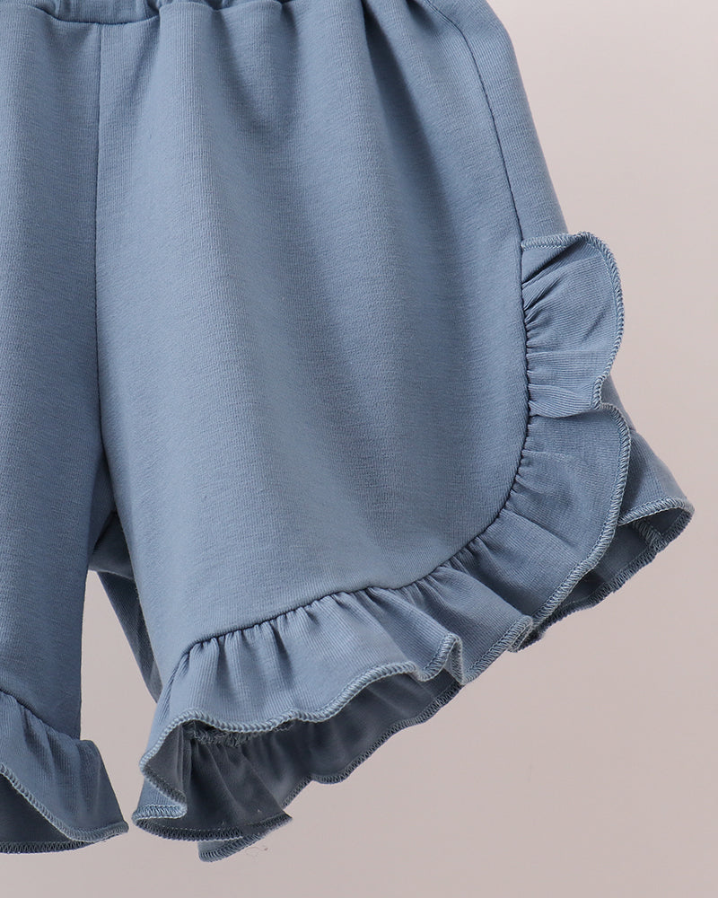 Light blue elastic-waist shorts with layered ruffle hem and side pocket