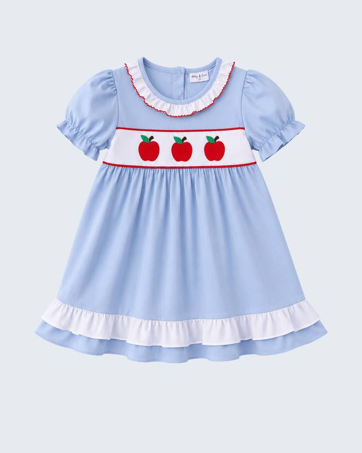 Light blue girls dress with puff sleeves, apple embroidery and red trim ruffled hem