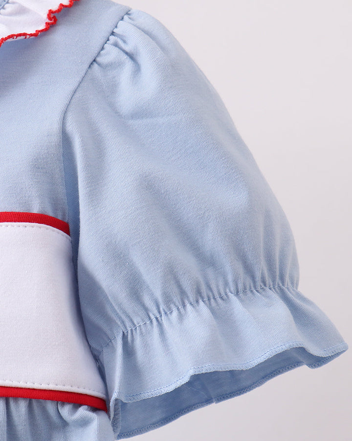 Light blue puff-sleeve dress with gathered shoulder seam and red waistband trim