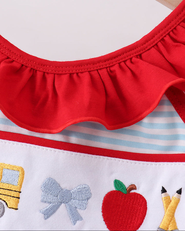 Red neckline with gathered trim and colorful embroidered apple pencil motifs