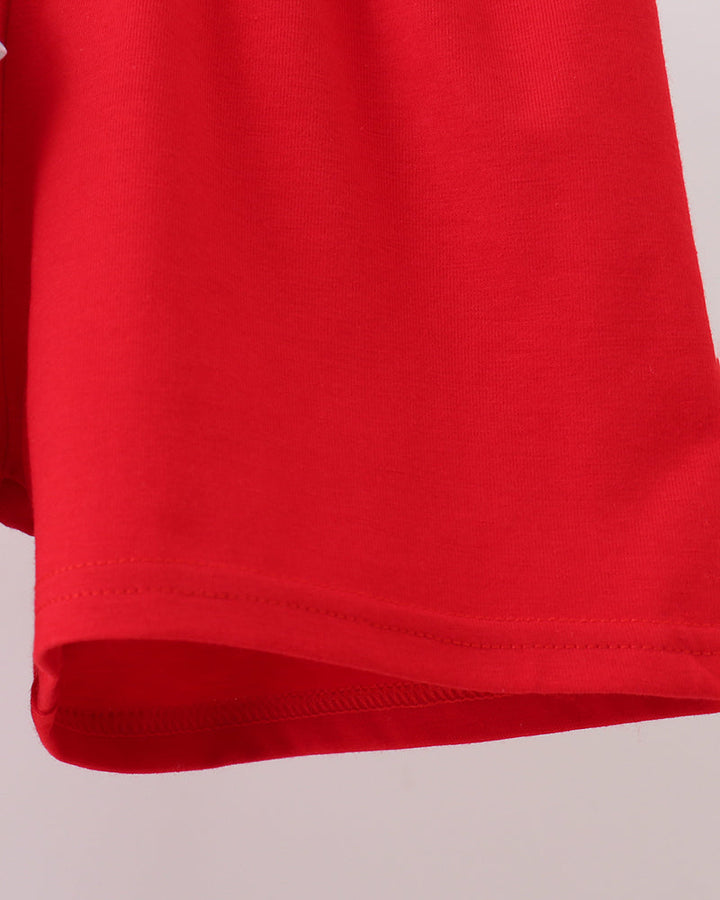 Red shorts with smooth hem and visible stitching at the bottom edge.