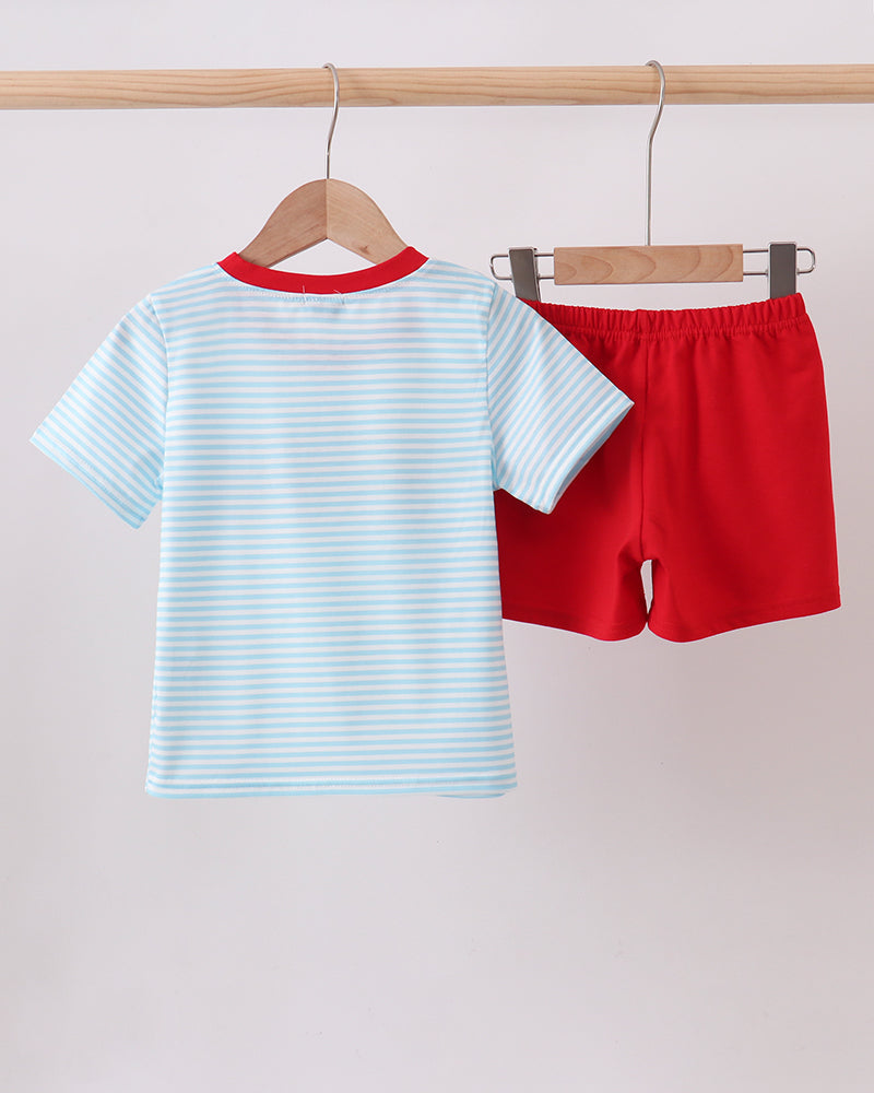 Kids striped light blue T-shirt and red shorts set, hanging on wooden hangers.