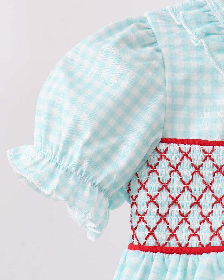 Light blue dress with red embroidery on a light gray background