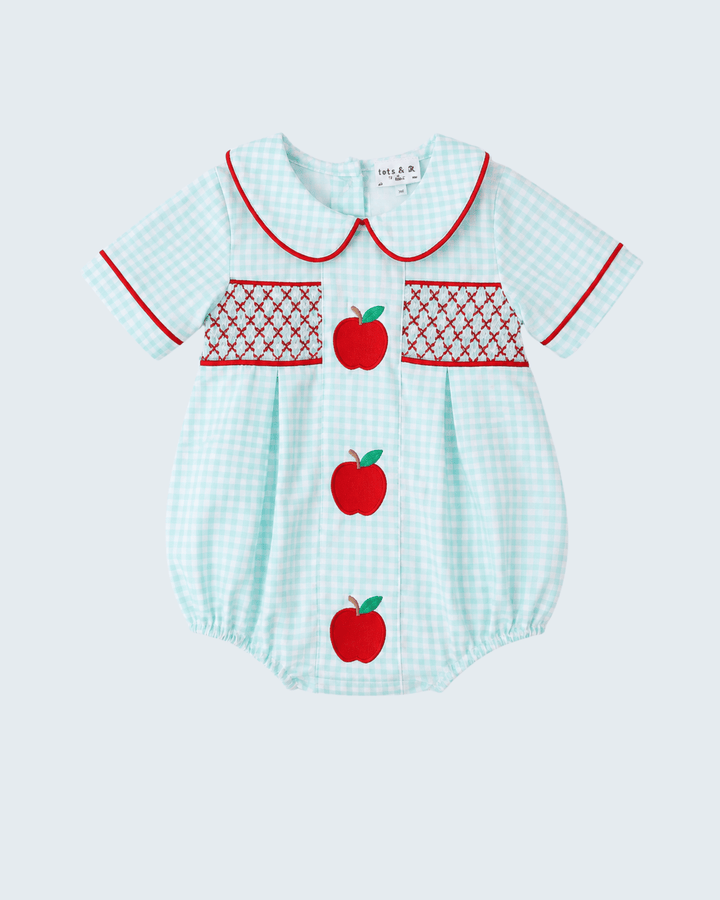 Light blue checkered baby romper with red apple designs on a white background