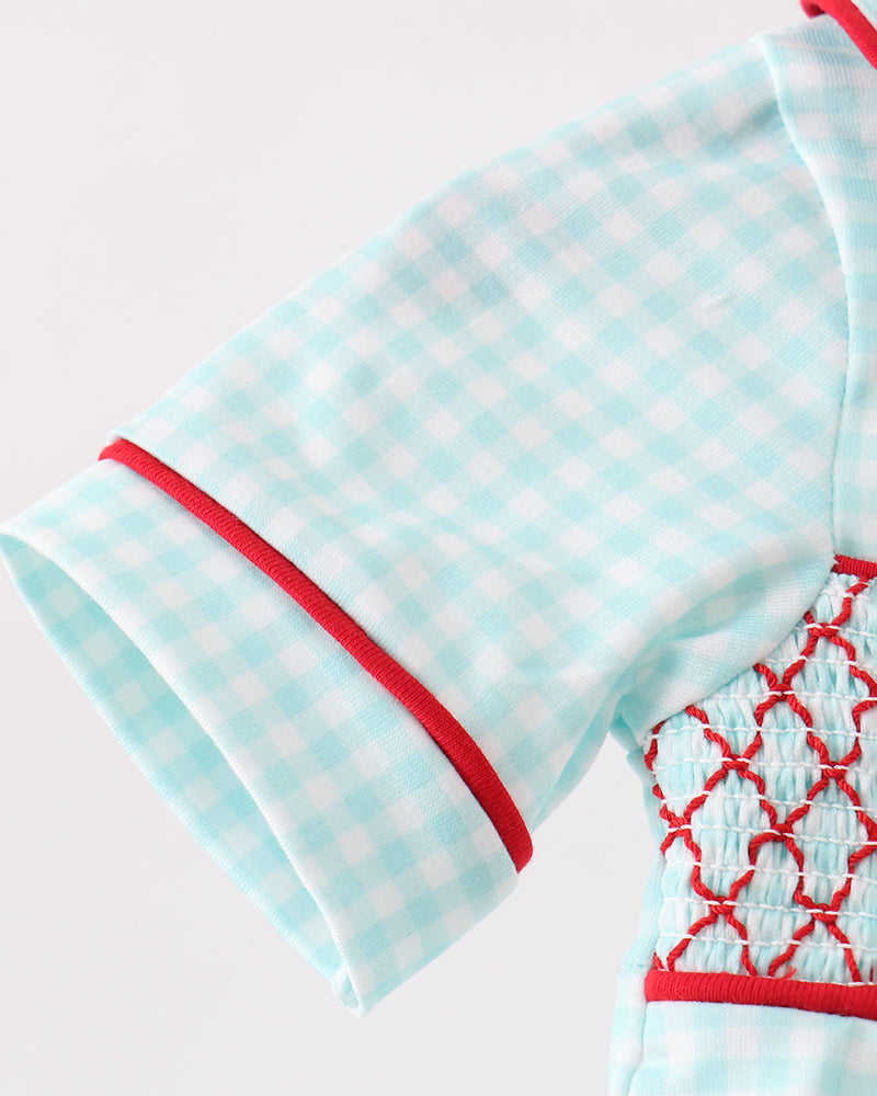 Light blue baby outfit with red accents on a white background