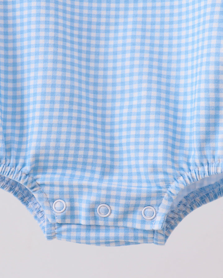 Light blue gingham bubble romper with three-snap closure at leg opening and gathered hem