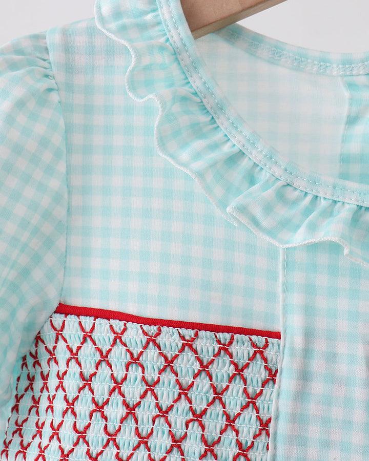 Light blue checkered dress with red pattern on a white background