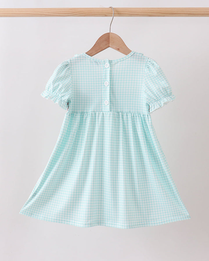 Light blue checkered dress on a hanger against a plain background