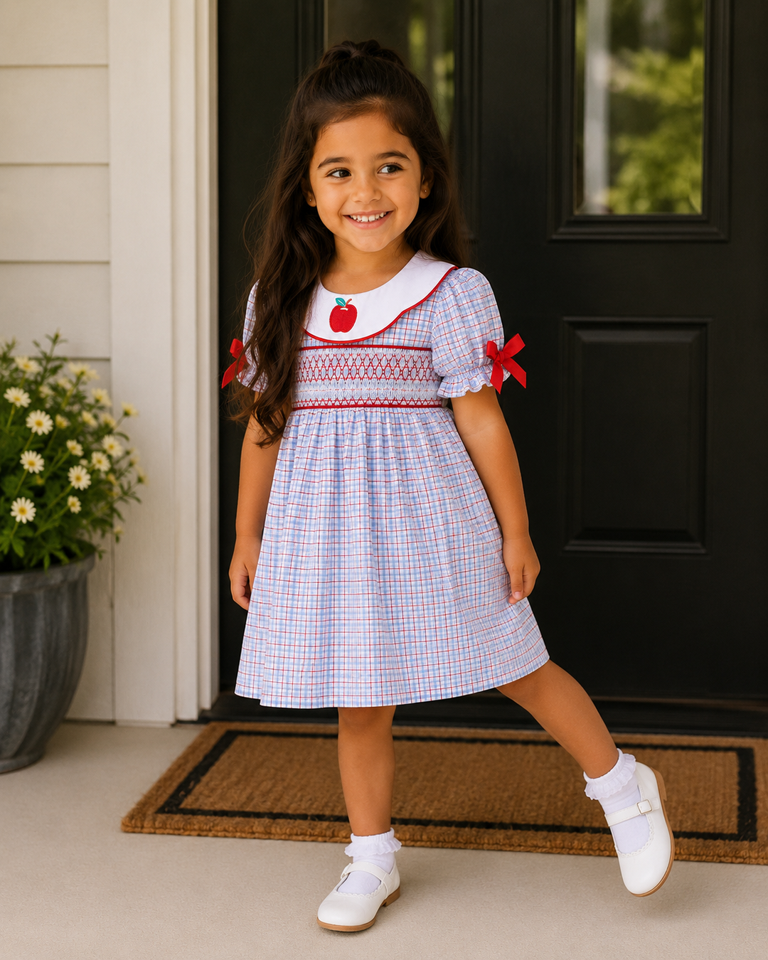 Young girl is standing by black front door