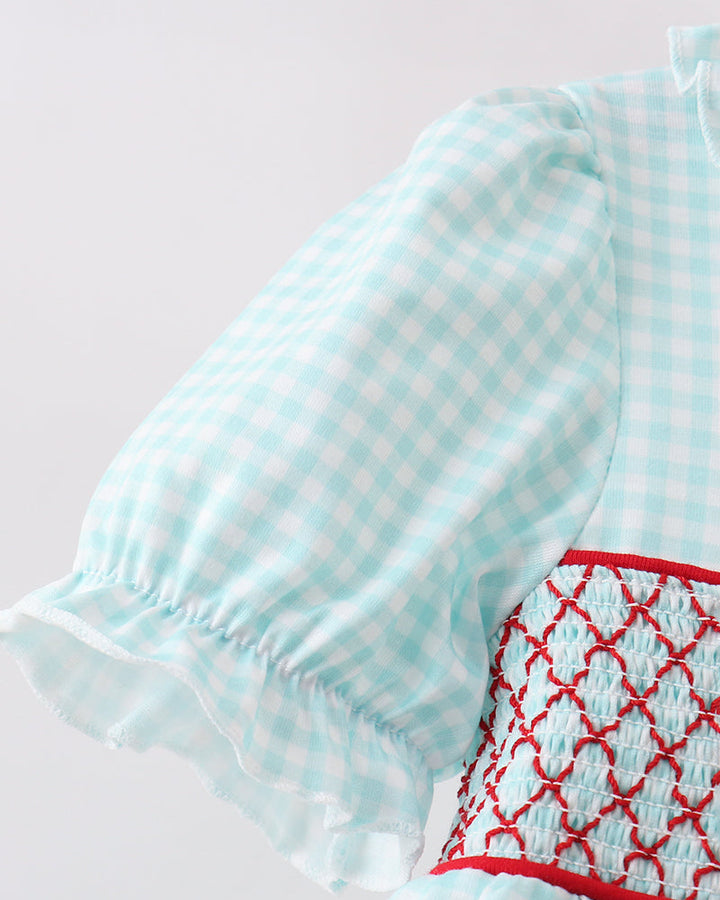 Light blue checkered dress with red embroidery on a light gray background