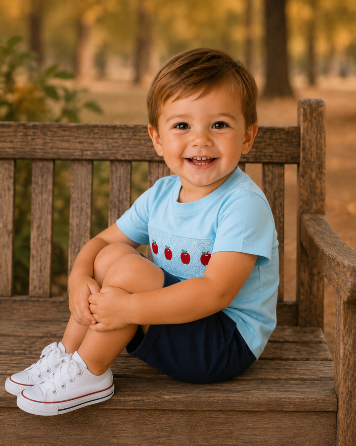 Light blue apple graphic top worn by toddler, short sleeves