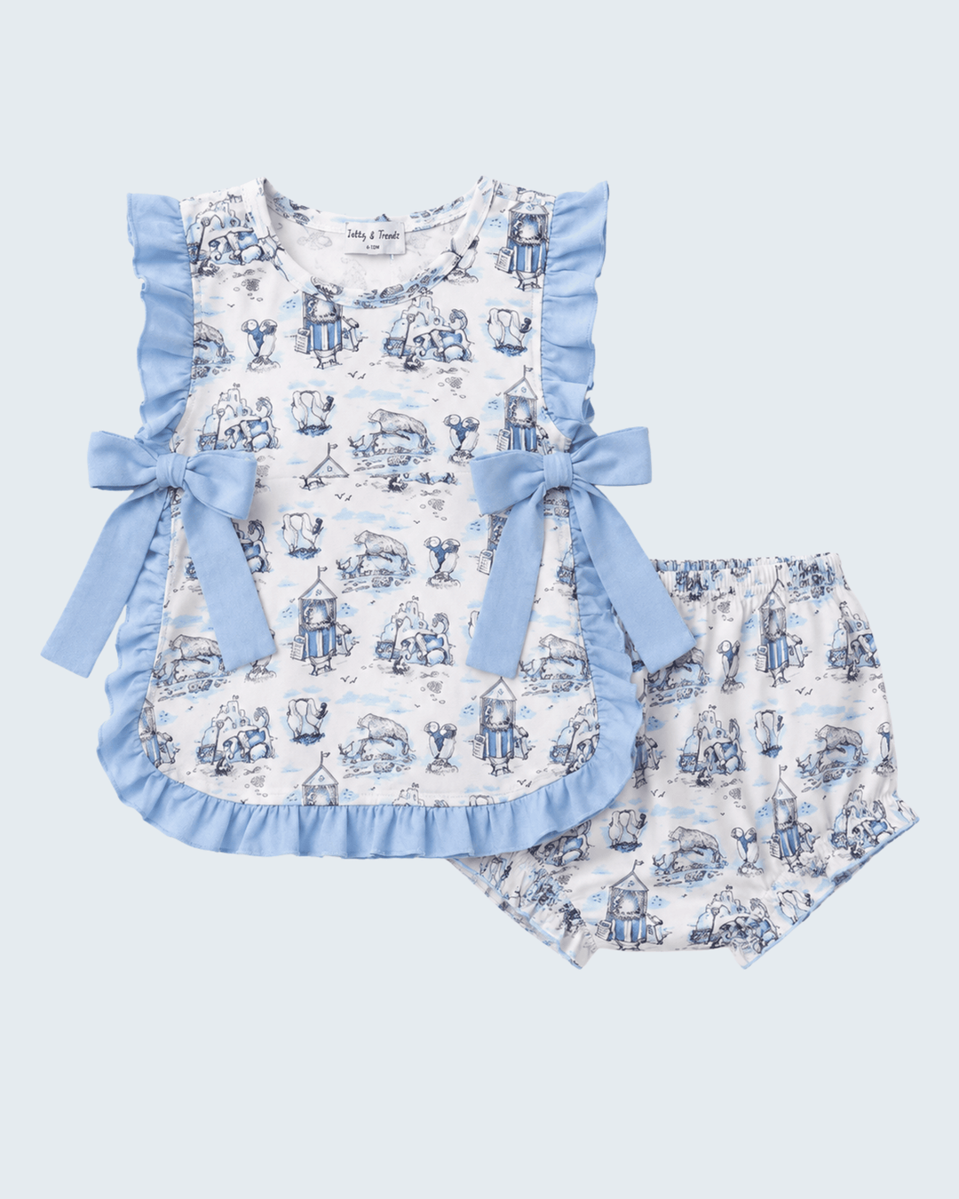 Children's outfit with a patterned top and shorts on a light blue background