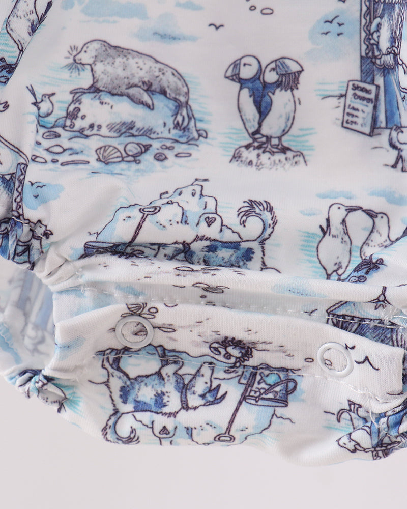 Close-up of fabric with blue and white animal illustrations on a white background