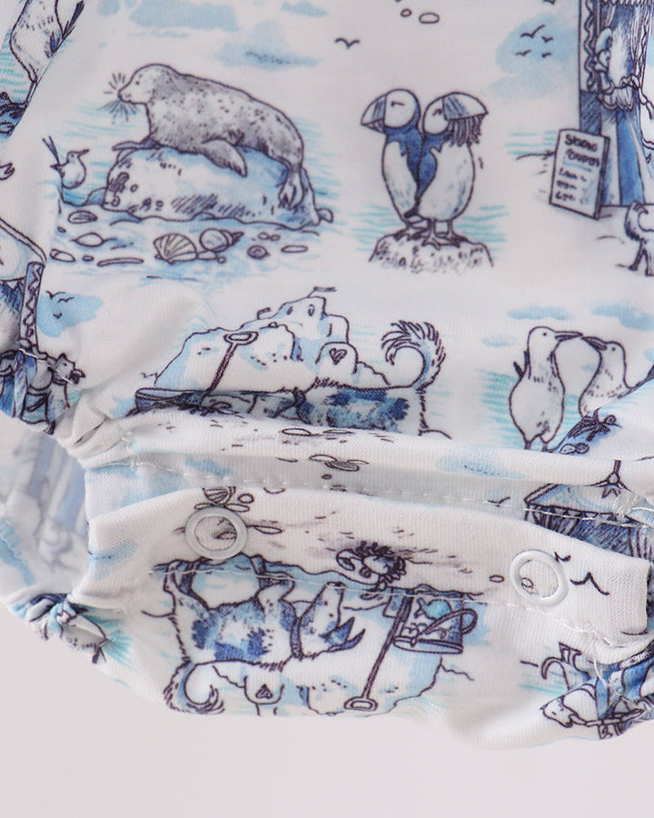 Close-up of fabric with blue and white animal illustrations on a white background
