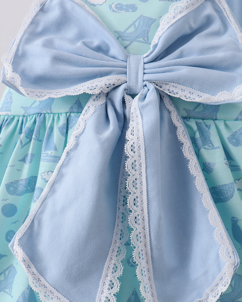Light blue bow with lace trim on a patterned dress