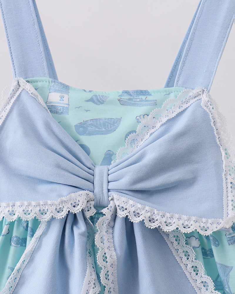 Light blue lace-trimmed dress with whale pattern on a white background