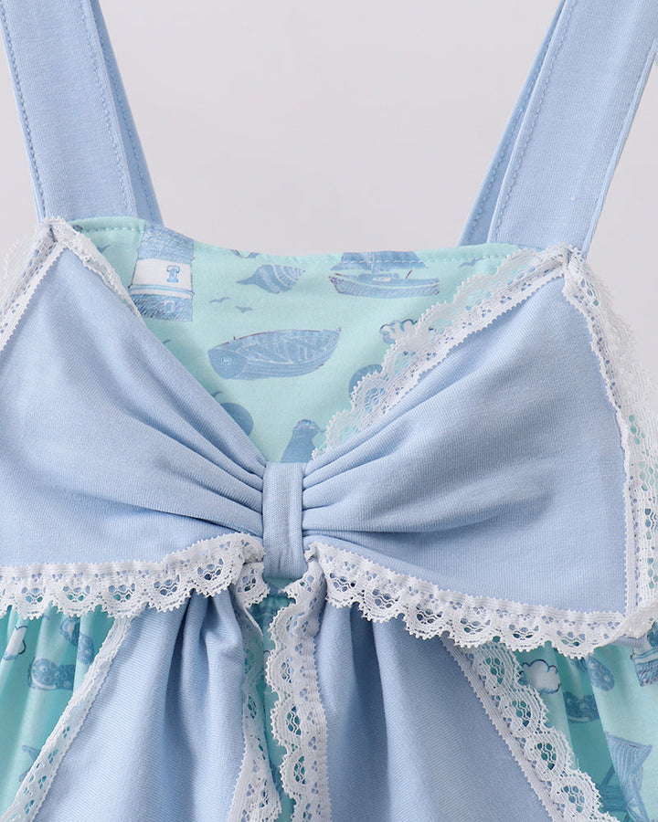 Light blue lace-trimmed dress with whale pattern on a white background