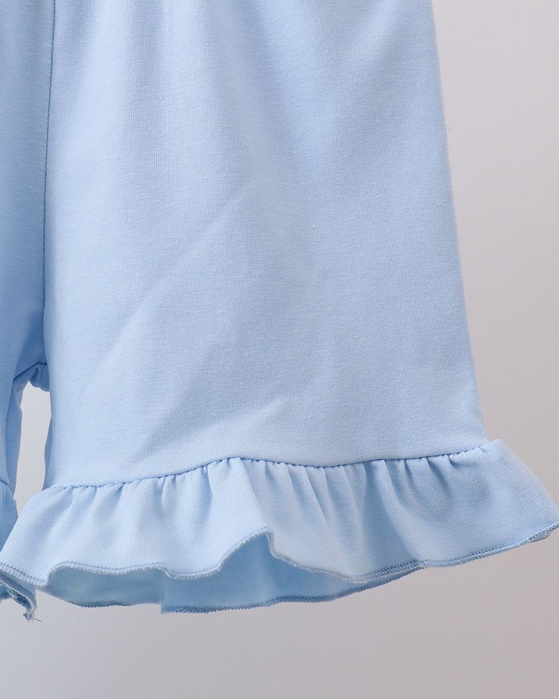 Light blue shorts with ruffled hem on a plain background