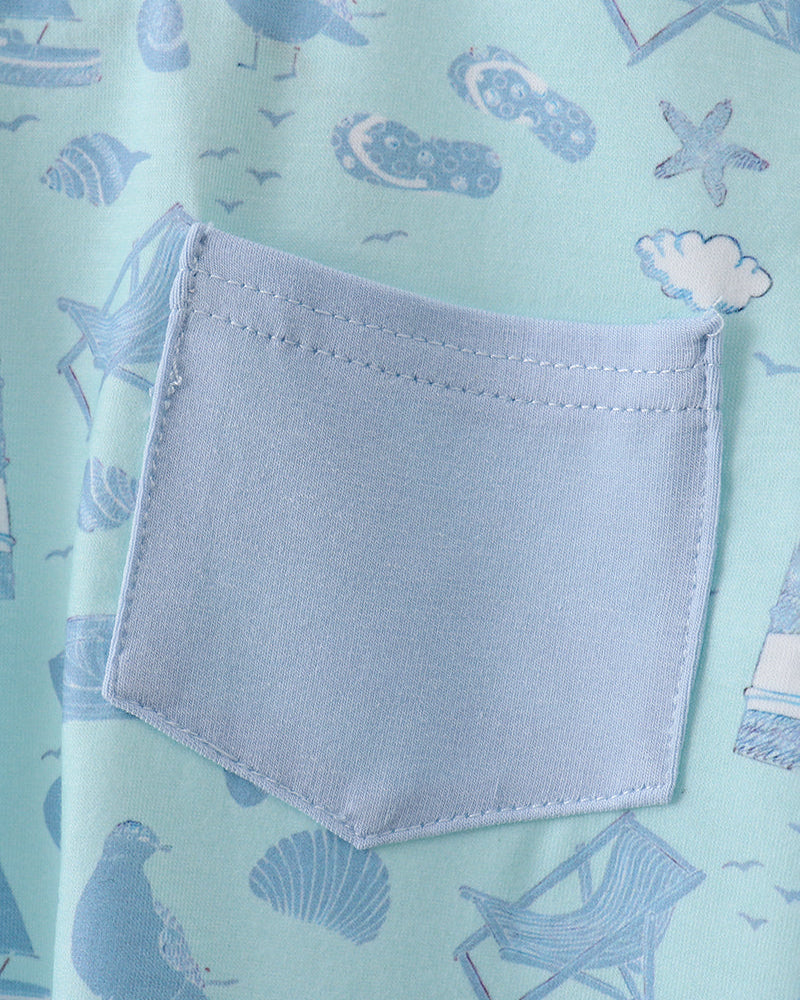 Light blue fabric with a pocket and beach-themed pattern on a light green background