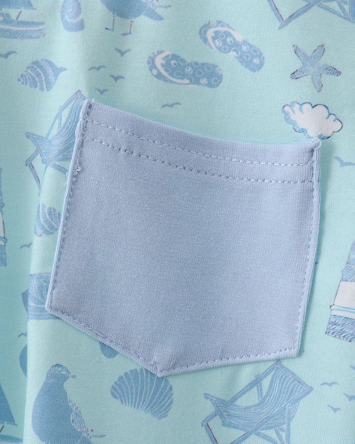 Light blue fabric with a pocket and beach-themed pattern on a light green background