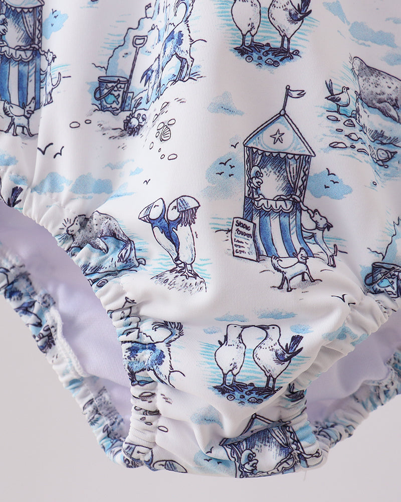 Rashguard with a blue and white nautical-themed print on a light gray background