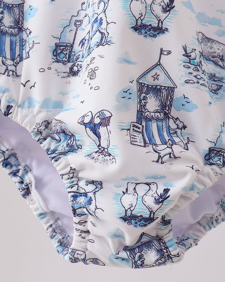 Rashguard with a blue and white nautical-themed print on a light gray background