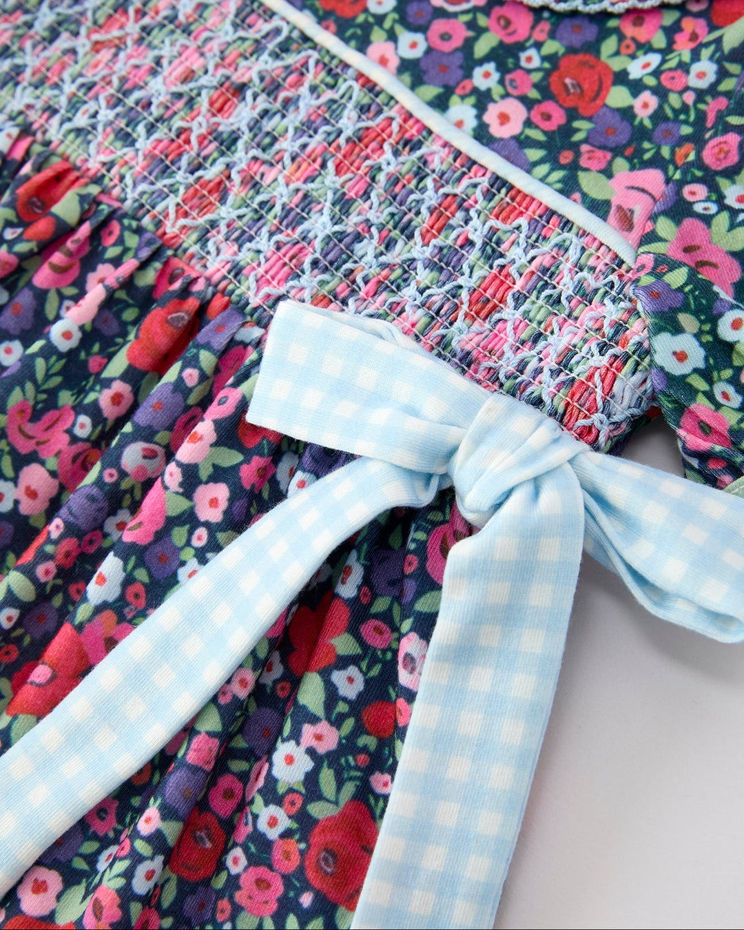 Floral smocked dress with light blue gingham ribbon bow detail