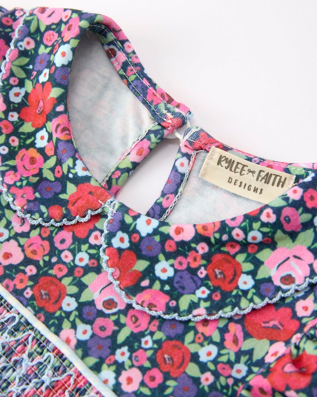 Girls floral smocked dress neckline with inner tag and open collar