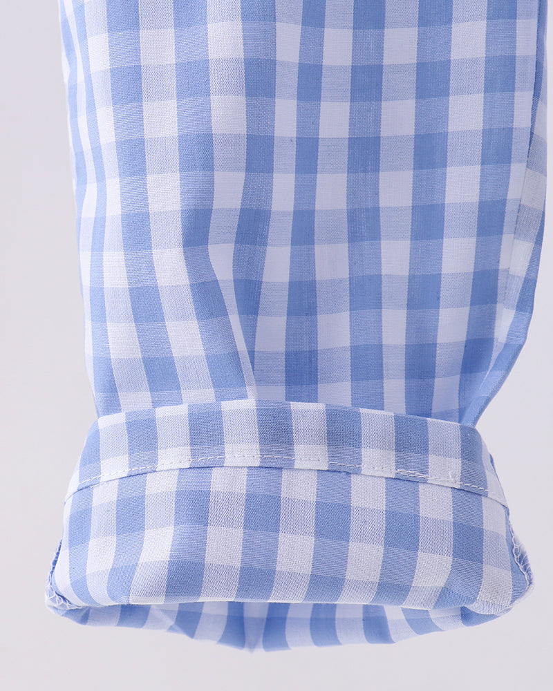 Close-up of a blue and white checkered fabric on a light gray background
