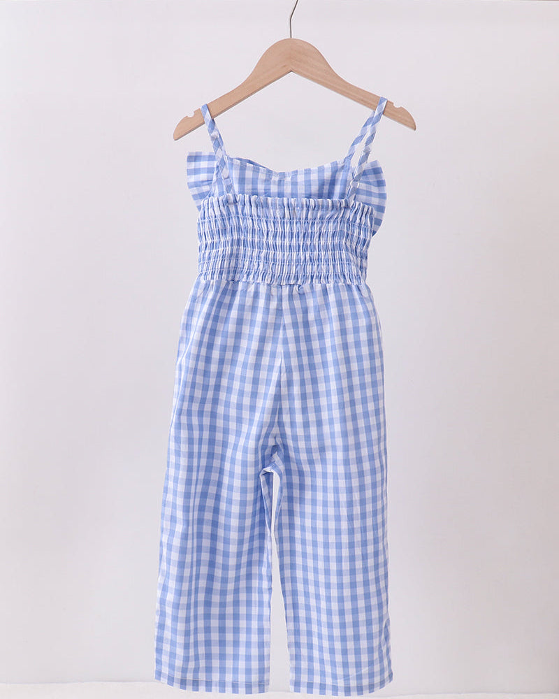 Blue and white checkered jumpsuit on a hanger against a white background