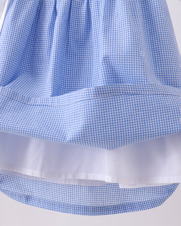Blue checkered dress with a white ribbon on a white background