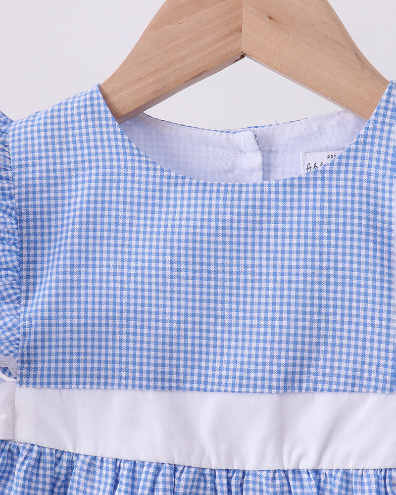 Blue and white checkered dress on a wooden hanger with a white background
