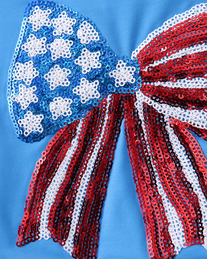 Sequin bow on blue fabric