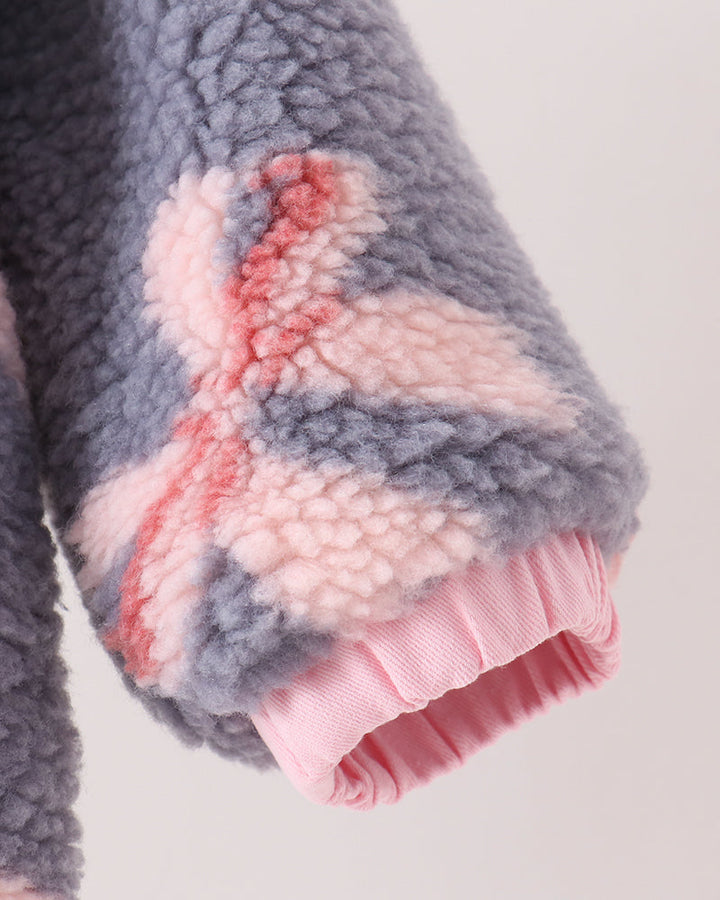 Puffy sherpa fleece sleeve cuff with pink lining, bow pattern on dark blue