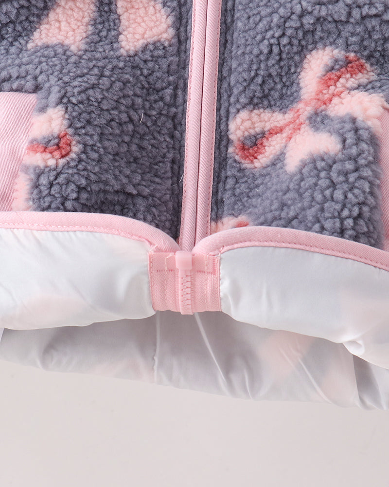 Fleece jacket hem with pink zipper placket and white windguard lining